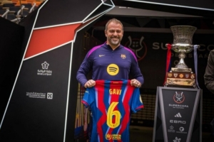 弗里克手拿加维球衣与西超杯奖杯合影，据悉球员将现场观看决赛